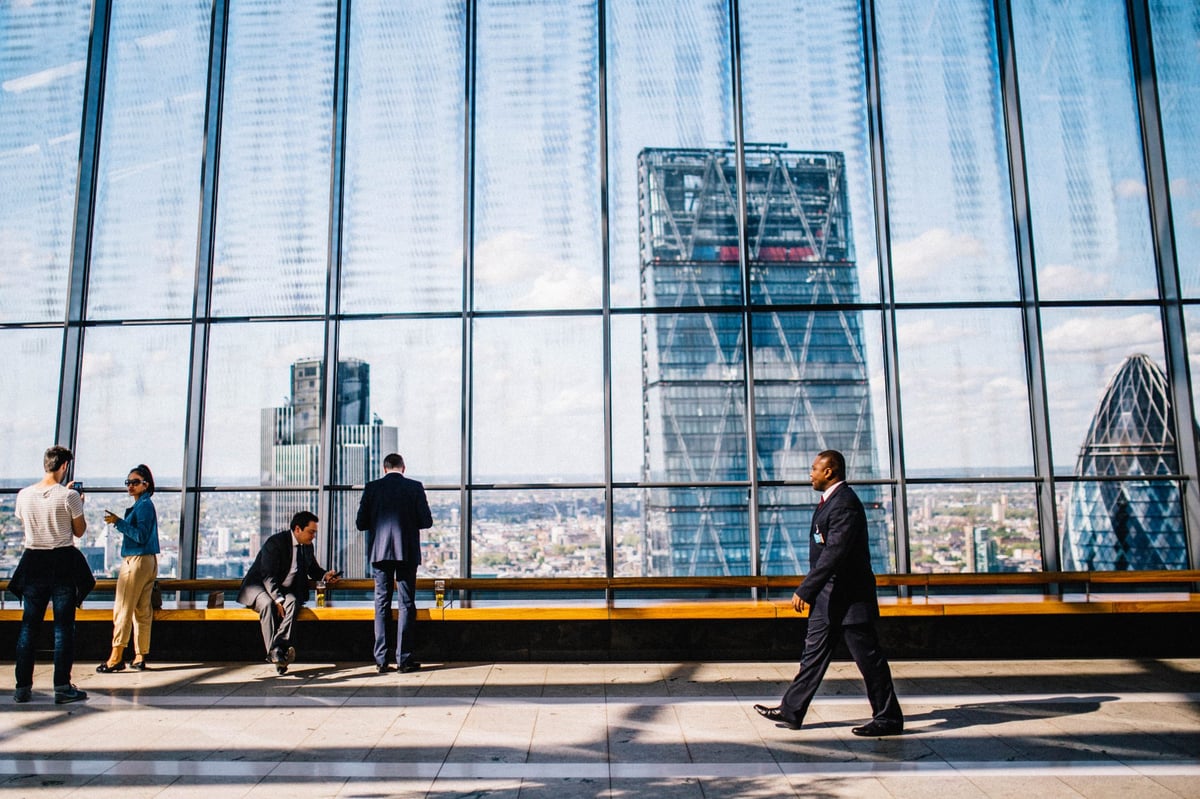 business people in front of large windows