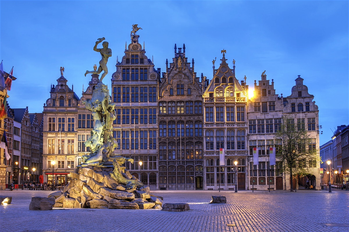 antwerp belgium at night baroque buildings lights statue blue sky clouds