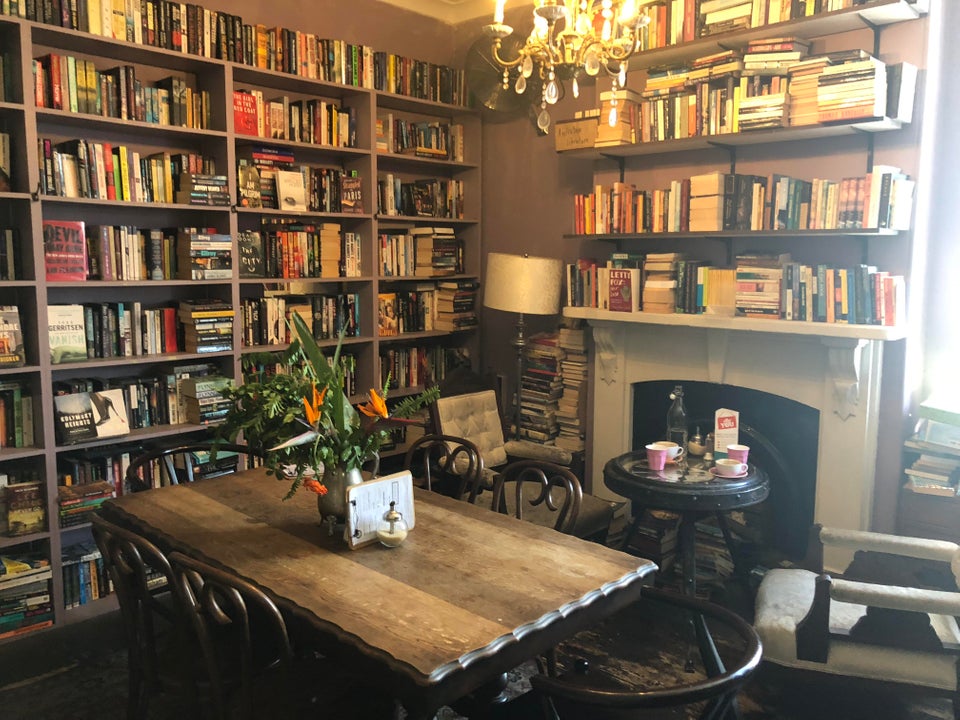 Image of a bookstore with a table and books on the walls