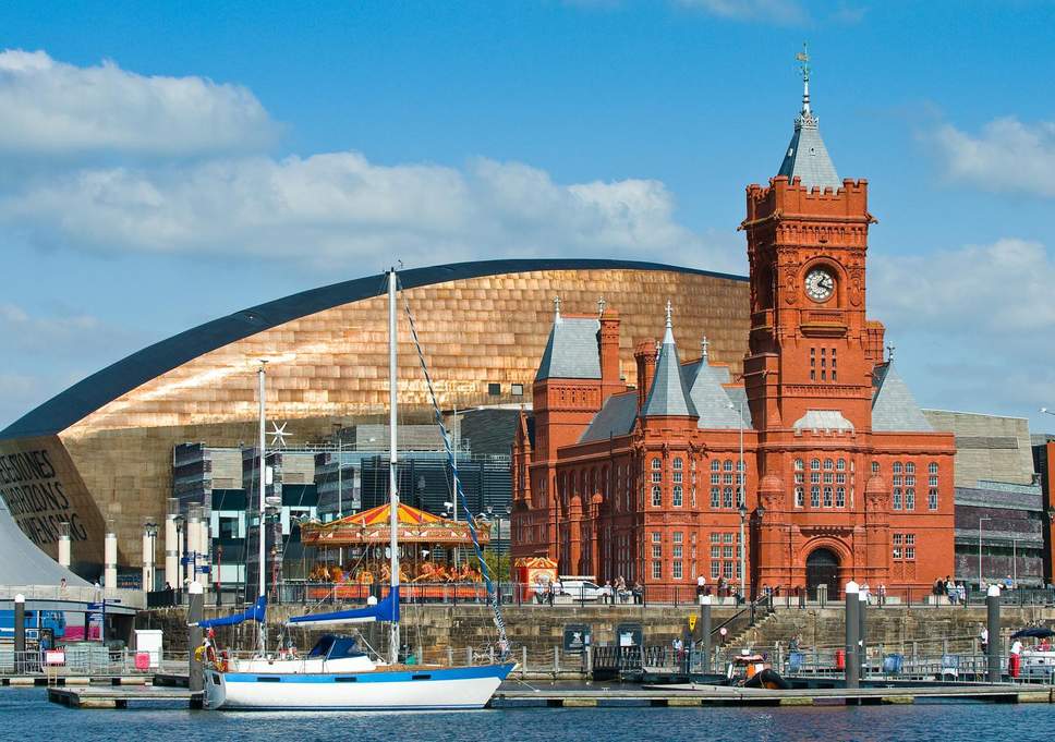 view of cardiff wales uk boats on the water modern architecture and old town hall