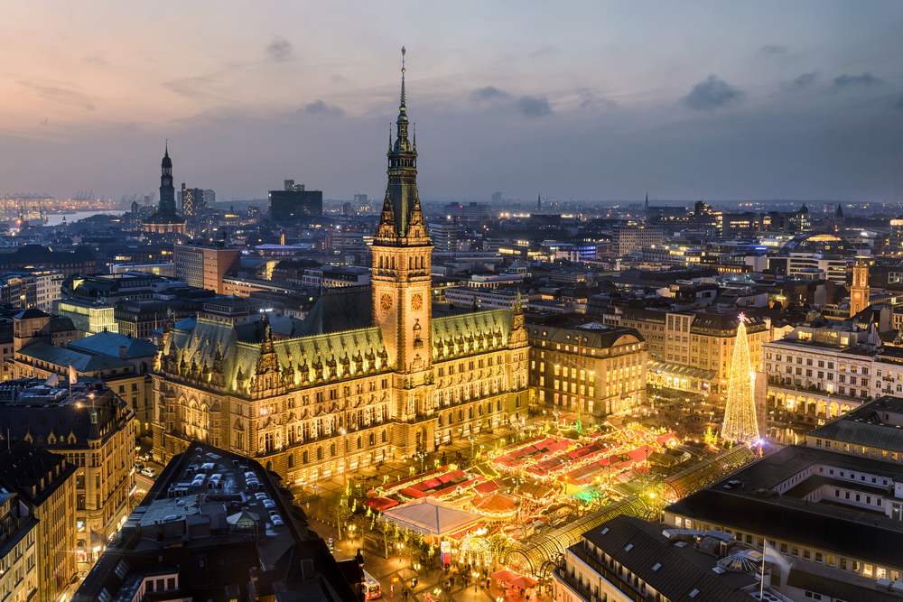 hamburg town hall in germany town square at night many buildings and cloudy sky