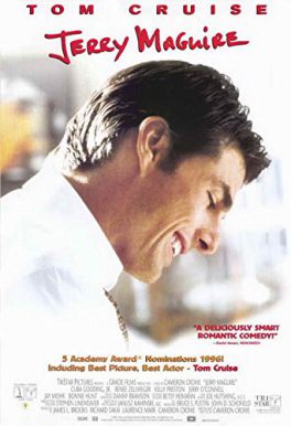 Tom Cruise looking down and smiling wearing a white shirt with his background out of focus red black and gold lettering overlaid