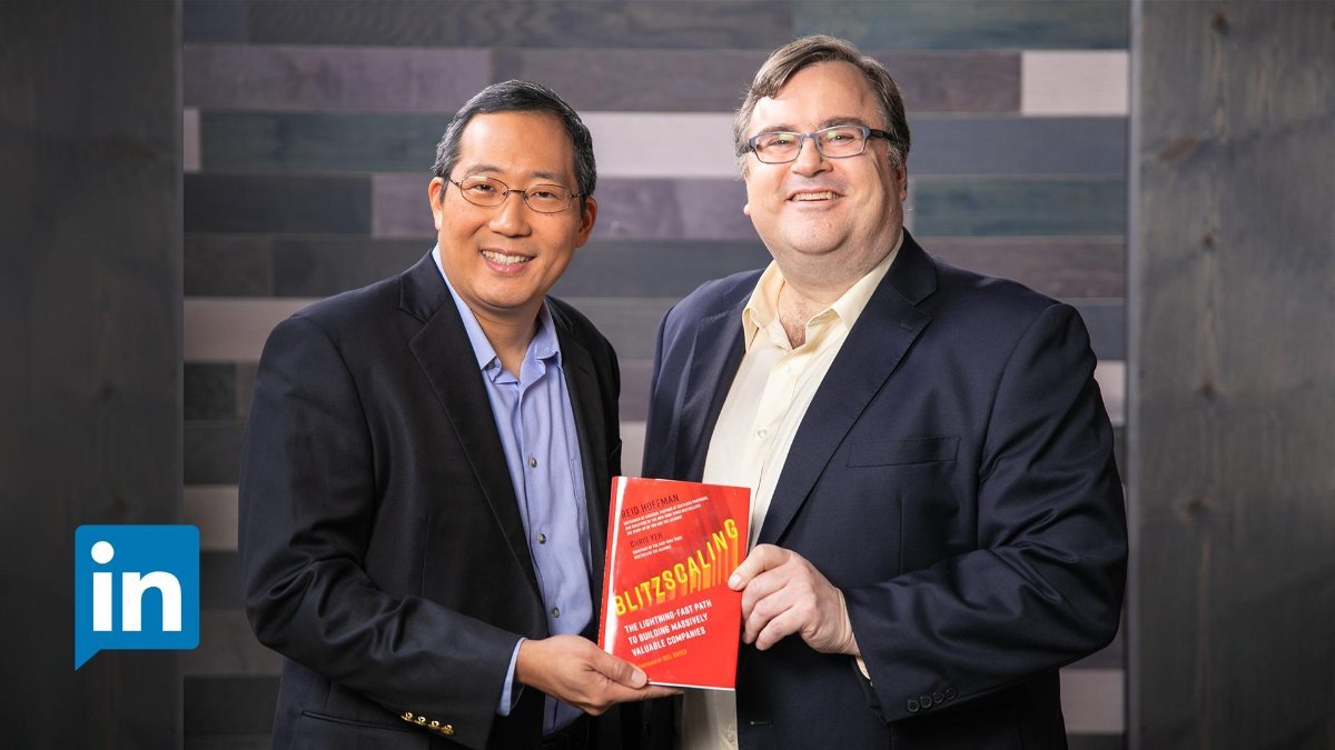 Photo of Reid Hoffmann and Chris Yeh holding the book "blitzscaling"