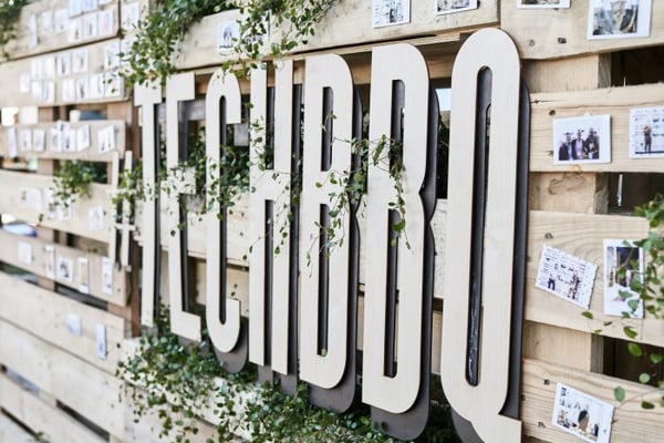 Tech-BBQ logo on wooden paneling