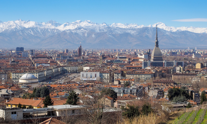 view of turin italy church old buildings trees mountains blue sky