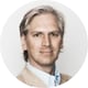 man, blond hair, wearing white shirt and light blue suit