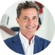 smiling man, grey hair, white shirt, blue suite