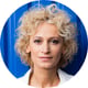 woman, white shirt, necklace, blond hair, blue background