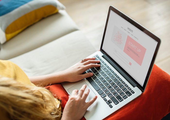 Person using computer on couch