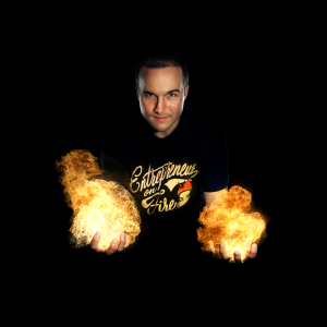 Entrepreneurs on fire - man holding fireballs in his hand with black t-shit on a black background