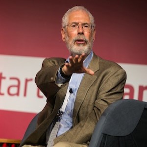 Stave Blank photo with suit and shirt with white hair and beard on red and whit background