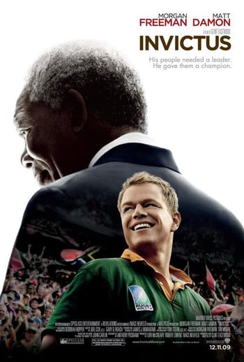 Invictues movie poster - smiling man wearing rugby shirt looks to a crowd of cheering supporters, separately a man wearing a suit looks down, white background