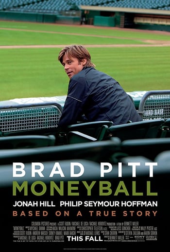 Moneyball movie poster - man wearing black jacket sits with his back to camera, looking at camera, in a sports field, white text overlaid