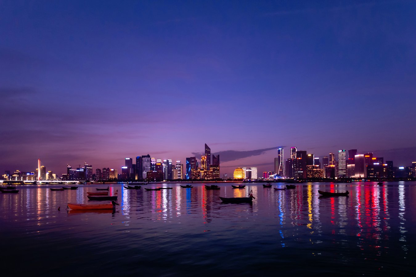 hangzhou skyline from water at dusk