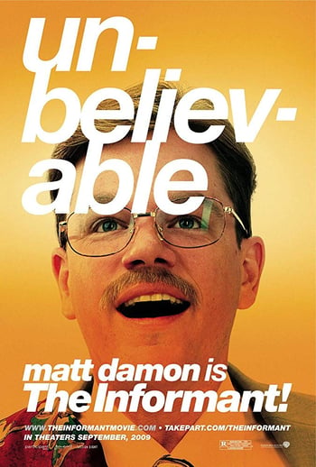 The informant! movie poster - close up of a mans face, smiling wearing glasses on a yellow background, white text overlaid