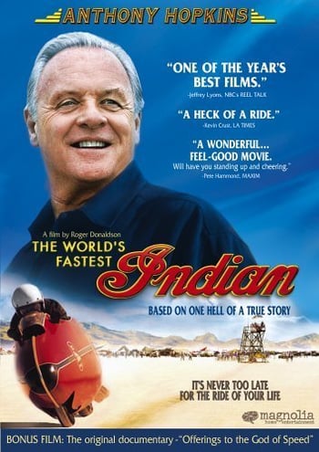 The world's fastest Indian movie poster - An old man wearing a blue shirt looks away, separately a man on a vehicle speeds through the dessert, red text overlaid