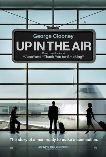 Up in the air mocie poster - in an airport terminal the silhouette of a man looks out of the window at a plane, the title of the film is in white lettering placed in a boarding screen