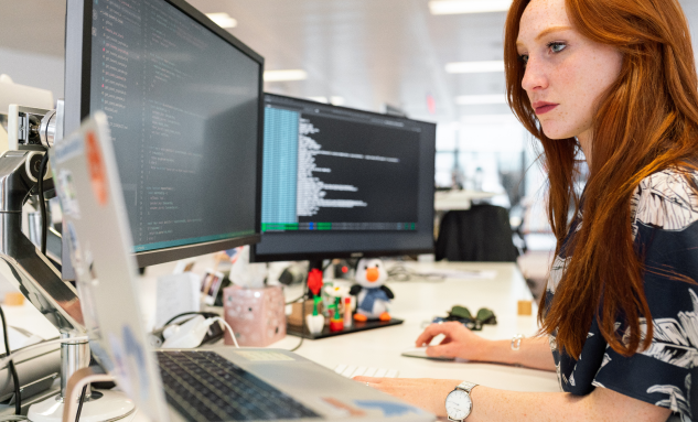 Woman in from of computer screens 